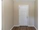 Simple bathroom with white door and hardwood floor at 1300 Mercy Dr, Orlando, FL 32808