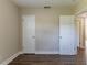 Empty bedroom with two closets and dark wood-look flooring at 1300 Mercy Dr, Orlando, FL 32808