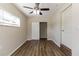 Bedroom with ceiling fan, closet, and dark wood-look flooring at 1300 Mercy Dr, Orlando, FL 32808