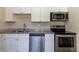 Modern kitchen with stainless steel appliances and granite countertops at 1300 Mercy Dr, Orlando, FL 32808