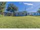 Large grassy backyard with a view of neighboring homes at 1300 Mercy Dr, Orlando, FL 32808