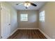 Simple bedroom with hardwood floors and ceiling fan at 1300 Mercy Dr, Orlando, FL 32808