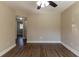Spacious bedroom with hardwood floors and ceiling fan at 1300 Mercy Dr, Orlando, FL 32808
