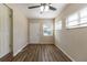 Simple bedroom with hardwood floors and ceiling fan at 1300 Mercy Dr, Orlando, FL 32808