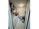 Small laundry room with washer, dryer, and shelving at 6110 Peregrine Ave # E05, Orlando, FL 32819