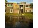 Two-story condo building with stairs leading to the entrance at 6110 Peregrine Ave # E05, Orlando, FL 32819