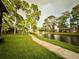 Serene waterfront view with a rainbow and walking path at 6110 Peregrine Ave # E05, Orlando, FL 32819