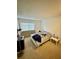 Comfortable bedroom featuring a queen-size bed and window view at 6110 Peregrine Ave # E05, Orlando, FL 32819