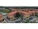 Aerial view of an apartment building complex with red tile roofs at 907 Charo Pkwy # 923, Davenport, FL 33897