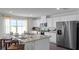 Spacious kitchen featuring granite island, stainless steel appliances, and hardwood floors at 2737 Flushing Dr, Apopka, FL 32703