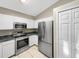 Kitchen boasts stainless steel appliances and white cabinets at 1048 Universal Rest Pl, Kissimmee, FL 34744