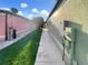 Sidewalk between two houses, showing exterior utilities and landscaping at 1048 Universal Rest Pl, Kissimmee, FL 34744