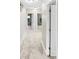 Bright hallway with neutral walls and carpet, leading to bedrooms at 1048 Universal Rest Pl, Kissimmee, FL 34744