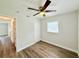 Comfortable bedroom with ceiling fan, wood-look floors, and closet at 925 Golden Isle Dr, Mount Dora, FL 32757