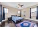 Well-lit bedroom with a queen bed, dark wood floors, and ceiling fan at 15716 Panther Lake Dr, Winter Garden, FL 34787