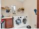 Laundry room with washer, dryer, and storage at 15716 Panther Lake Dr, Winter Garden, FL 34787