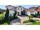 Elegant two-story home with a brick driveway and lush landscaping at 15716 Panther Lake Dr, Winter Garden, FL 34787