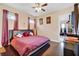 King-size bed, dark wood floors, and ensuite access at 15716 Panther Lake Dr, Winter Garden, FL 34787