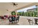 Covered patio with seating area, dining table and backyard view at 15716 Panther Lake Dr, Winter Garden, FL 34787
