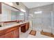 Double vanity bathroom with granite countertop and walk-in shower at 15716 Panther Lake Dr, Winter Garden, FL 34787
