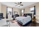 Spacious bedroom with a desk, dresser and a ceiling fan at 15716 Panther Lake Dr, Winter Garden, FL 34787