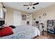 Comfortable bedroom with a queen bed, a workspace, and dark wood floors at 15716 Panther Lake Dr, Winter Garden, FL 34787