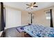 Serene bedroom with a queen bed, double doors to closet, and dark wood floors at 15716 Panther Lake Dr, Winter Garden, FL 34787