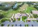 Aerial view of community clubhouse, golf course, and parking lot at 5825 Princess Caroline Pl, Leesburg, FL 34748