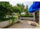 Private patio with brick pavers, lush landscaping, and lake view at 1000 Winderley Pl # 7, Maitland, FL 32751
