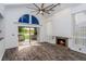 Living room with fireplace, wood floors and water view at 1000 Winderley Pl # 7, Maitland, FL 32751