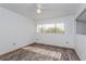 Spacious bedroom with wood-look flooring and large window at 1000 Winderley Pl # 7, Maitland, FL 32751