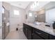 Clean bathroom with granite countertops, dark vanity, and a walk-in shower at 4457 Kaipo Rd, Davenport, FL 33897