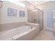 Relaxing bathroom with soaking tub, walk-in shower, and private access at 4457 Kaipo Rd, Davenport, FL 33897