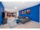 Entertainment area with large sectional, game tables, and mural at 4457 Kaipo Rd, Davenport, FL 33897