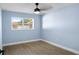 Light blue bedroom with wood-look floors and ceiling fan at 1925 Blossom Ln, Maitland, FL 32751