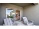 Relaxing covered patio with seating and view of the kitchen at 2749 Flushing Dr, Apopka, FL 32703