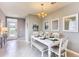 Bright dining room with white table, chairs, and chandelier at 1849 La Escalera Rd, Kissimmee, FL 34744