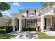 Two story tan townhome with red shutters and a paved driveway at 2364 Silver Palm Dr, Kissimmee, FL 34747