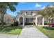 Two-story townhome with a red door and landscaped yard at 2364 Silver Palm Dr, Kissimmee, FL 34747