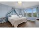 Serene bedroom with canopy bed and window seating at 2364 Silver Palm Dr, Kissimmee, FL 34747
