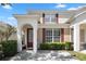 Two story tan townhome with red shutters and a paved driveway at 2364 Silver Palm Dr, Kissimmee, FL 34747
