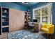Home office features a Murphy bed, built-in shelving, and a comfortable armchair at 2364 Silver Palm Dr, Kissimmee, FL 34747