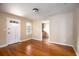 Living room with hardwood floors, neutral walls and view into kitchen at 1450 Ridgewood Ave, Maitland, FL 32751