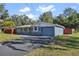 Newly painted house with a gray and white color scheme, a driveway, and a grassy lawn at 2084 Old New York Ave, Deland, FL 32720