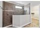 Modern bathroom with a large walk-in shower and glass enclosure at 5009 Torchwood Dr, Minneola, FL 34715