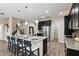Open kitchen with large island, stainless steel appliances, and pantry at 5009 Torchwood Dr, Minneola, FL 34715