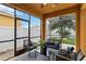 Enjoy this screened patio with comfortable seating and a view of the backyard at 5009 Torchwood Dr, Minneola, FL 34715