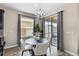 Cozy dining area with a round table and four chairs, near sliding glass doors at 5009 Torchwood Dr, Minneola, FL 34715