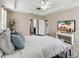 Primary bedroom featuring a king-size bed and ensuite bathroom access at 5009 Torchwood Dr, Minneola, FL 34715