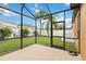 Spacious screened patio overlooking a lush green backyard at 5009 Torchwood Dr, Minneola, FL 34715